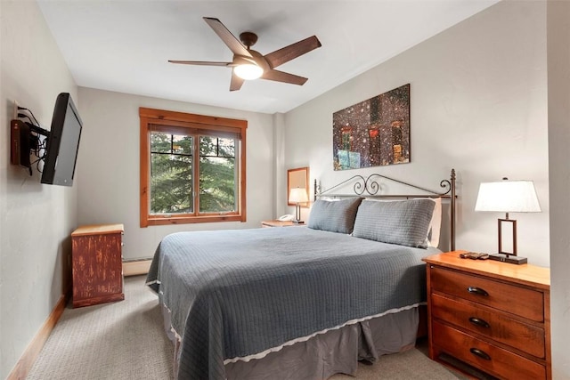 bedroom featuring a baseboard heating unit, carpet floors, baseboards, and a ceiling fan