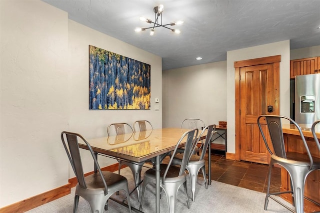 carpeted dining space featuring baseboards, a chandelier, and tile patterned flooring