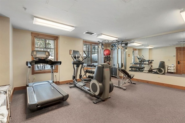 exercise room featuring visible vents and baseboards