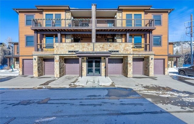 multi unit property featuring french doors and a balcony