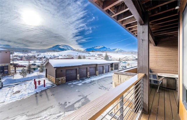 snow covered back of property with a mountain view