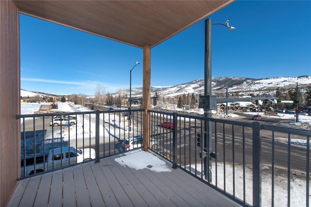 snow covered deck featuring a mountain view