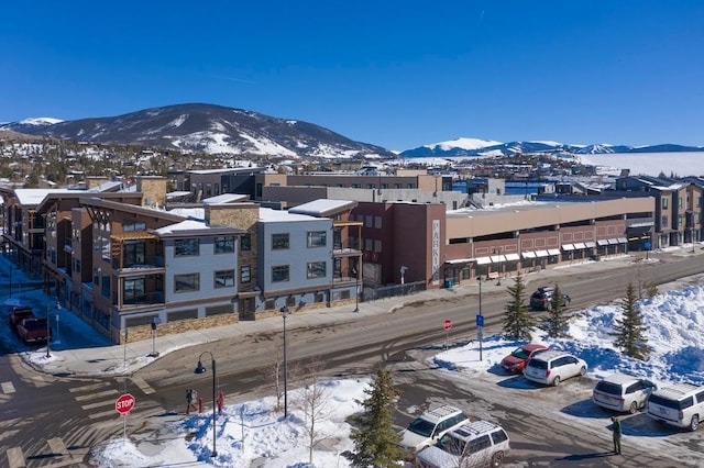 snowy aerial view featuring a mountain view