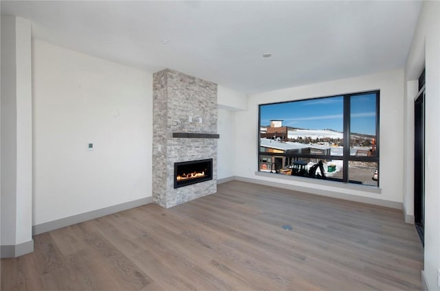 unfurnished living room featuring hardwood / wood-style floors and a fireplace