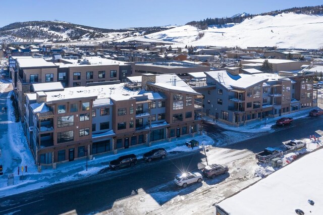 snowy aerial view with a mountain view