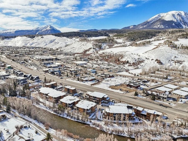 snowy aerial view with a mountain view