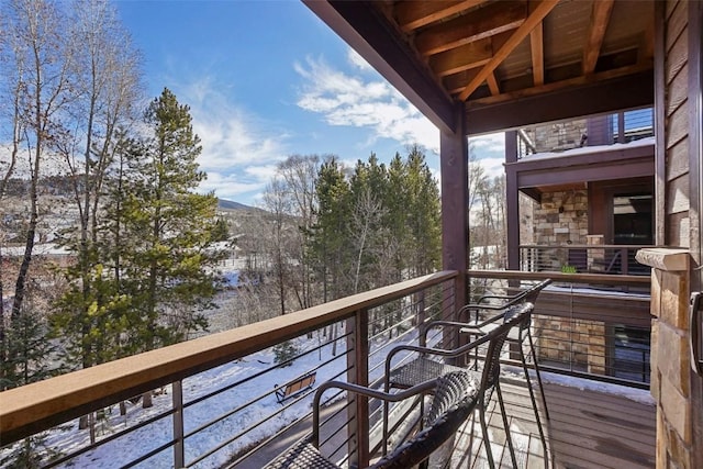 view of snow covered back of property