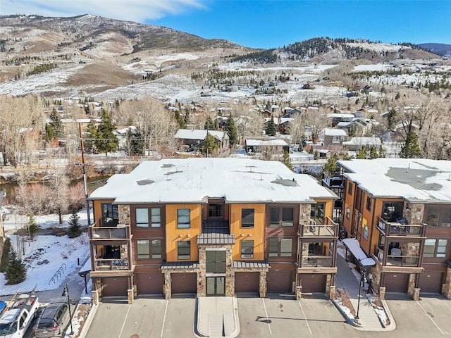 snowy aerial view featuring a mountain view