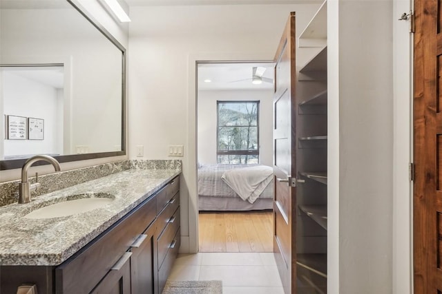 bathroom featuring tile patterned flooring, vanity, and ceiling fan