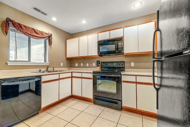 kitchen with light countertops, visible vents, white cabinetry, a sink, and black appliances