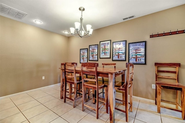 dining area with baseboards, visible vents, a notable chandelier, and light tile patterned flooring