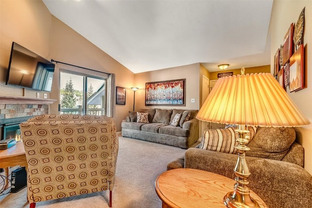 living room featuring vaulted ceiling, carpet flooring, and a tile fireplace