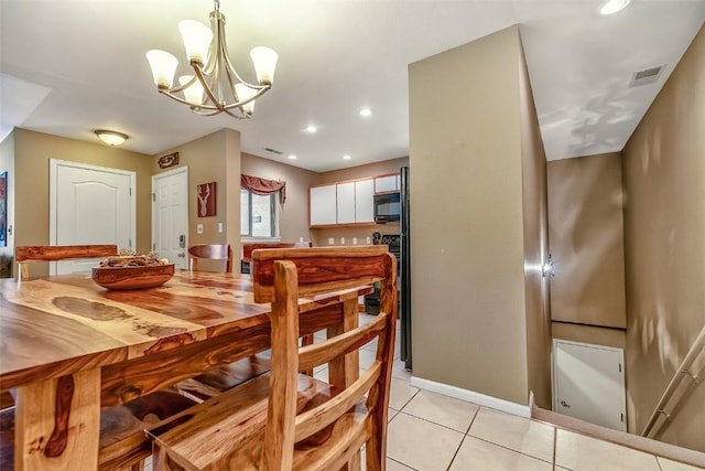 dining room with light tile patterned flooring, a notable chandelier, recessed lighting, visible vents, and baseboards