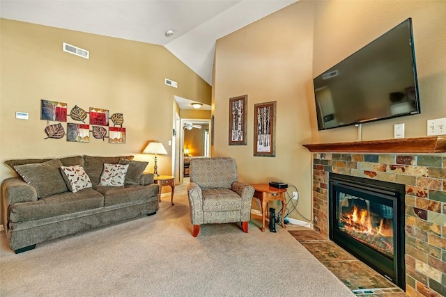 living area with a fireplace with flush hearth, visible vents, high vaulted ceiling, and carpet floors