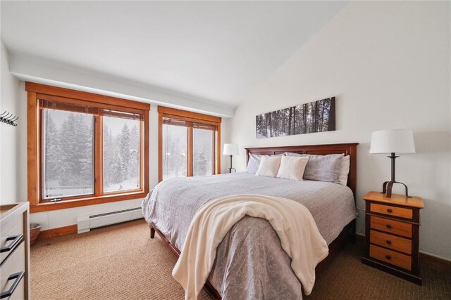 carpeted bedroom featuring a baseboard heating unit, lofted ceiling, and baseboards