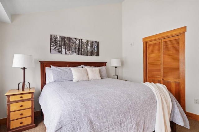 bedroom featuring a closet, carpet flooring, and vaulted ceiling