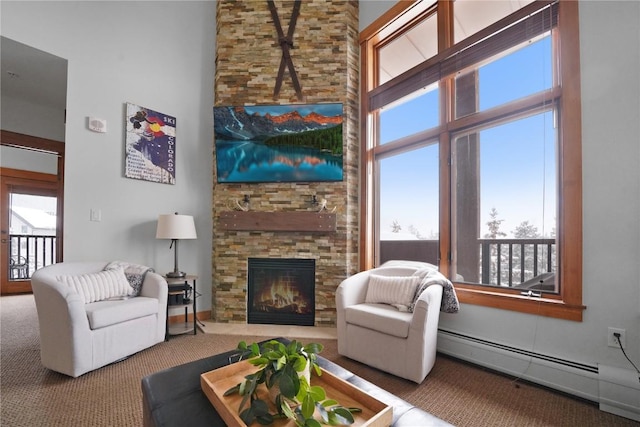 living room with a towering ceiling, plenty of natural light, and baseboard heating