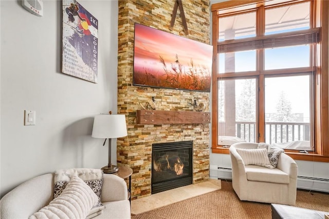 living area featuring a baseboard heating unit and a fireplace