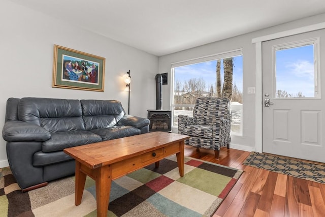 living room with hardwood / wood-style flooring and a wood stove