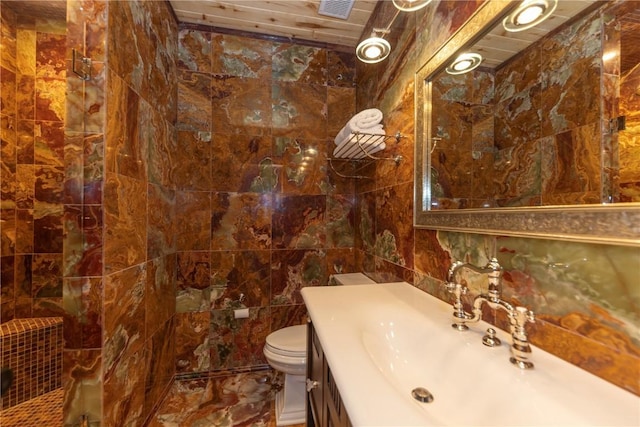 bathroom featuring toilet, tile walls, and vanity