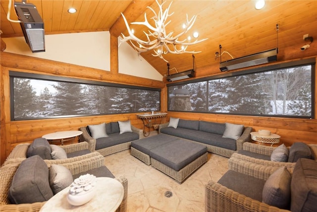 interior space featuring high vaulted ceiling, an inviting chandelier, wood walls, and wooden ceiling