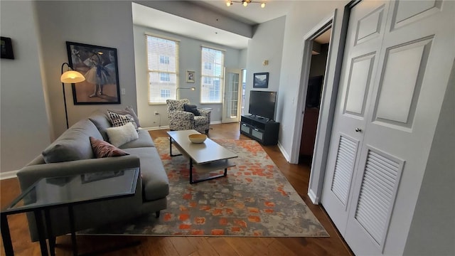 living area featuring baseboards and wood finished floors