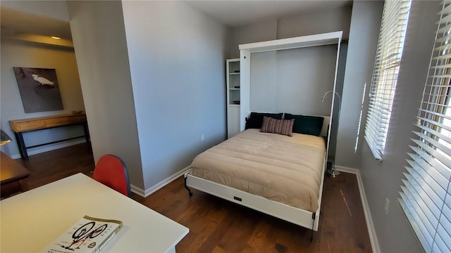 bedroom featuring dark wood-type flooring and baseboards