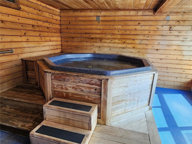 misc room featuring wood walls, a jacuzzi, and wooden ceiling