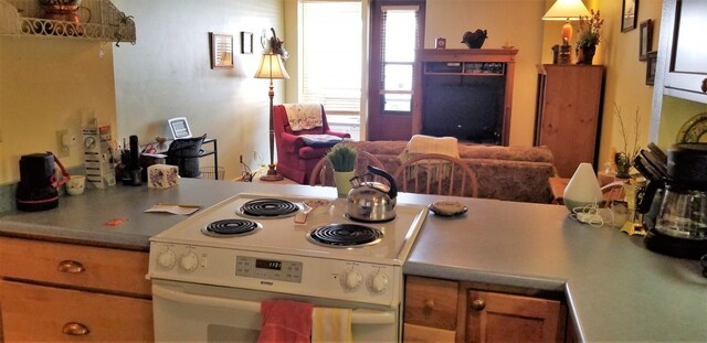 kitchen featuring tile patterned flooring, white appliances, and a sink