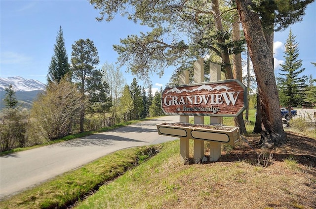 community sign with a mountain view