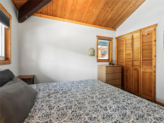 bedroom with lofted ceiling, wood ceiling, and a closet