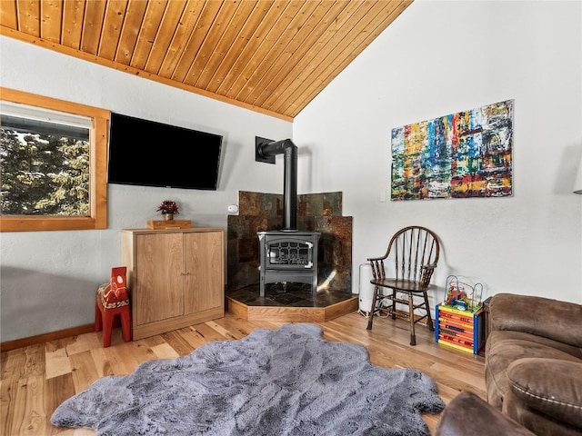 living room with wooden ceiling, vaulted ceiling, hardwood / wood-style floors, and a wood stove