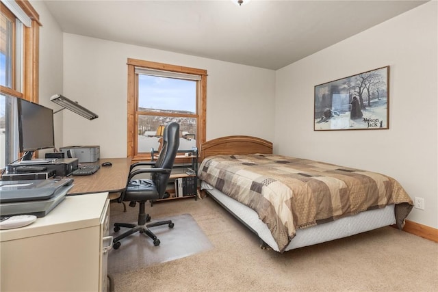 bedroom with baseboards and carpet flooring