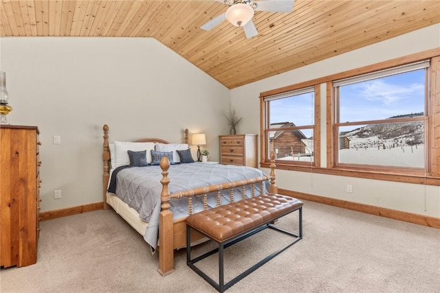 bedroom featuring light carpet, baseboards, wooden ceiling, ceiling fan, and vaulted ceiling