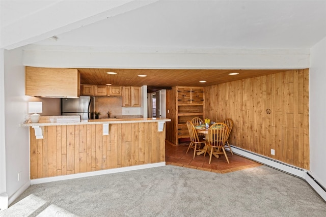 kitchen featuring carpet, a peninsula, freestanding refrigerator, light countertops, and wooden ceiling