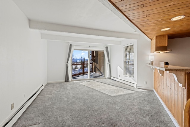 unfurnished living room featuring carpet floors, baseboard heating, and wooden ceiling