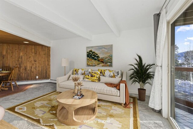 carpeted living area with baseboards, beam ceiling, baseboard heating, and wood walls