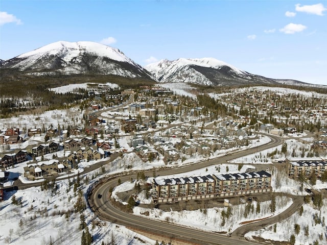 snowy aerial view featuring a residential view and a mountain view