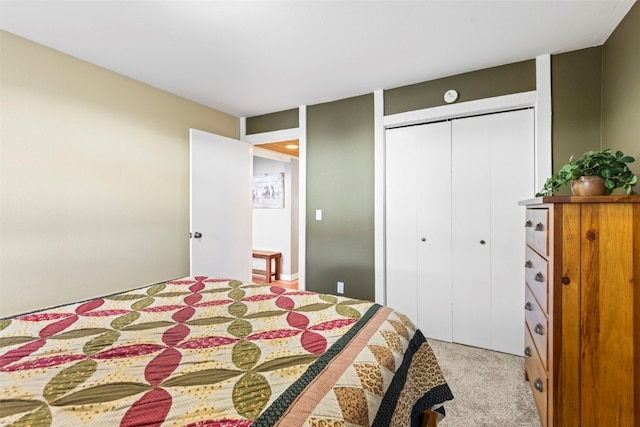 bedroom featuring a closet and light colored carpet