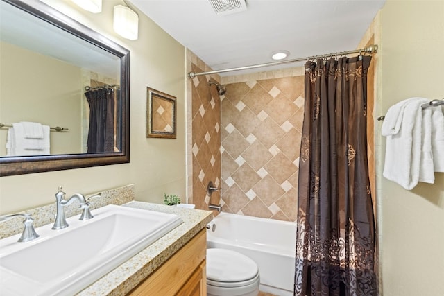 bathroom featuring visible vents, toilet, shower / bath combo, and vanity