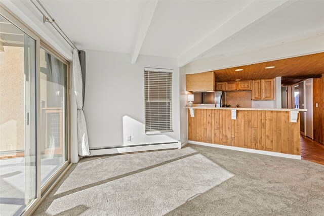 kitchen with brown cabinetry, carpet floors, a baseboard radiator, a peninsula, and light countertops