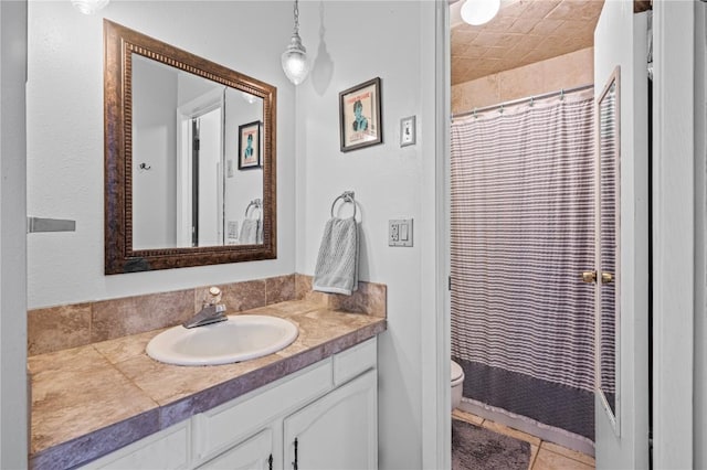 bathroom with vanity, tile patterned floors, toilet, and walk in shower