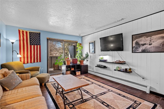 living room with dark hardwood / wood-style flooring, a baseboard radiator, wooden walls, and a textured ceiling