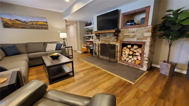 living room featuring wood-type flooring and a fireplace