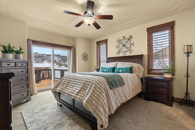 bedroom with access to outside, light colored carpet, and ceiling fan