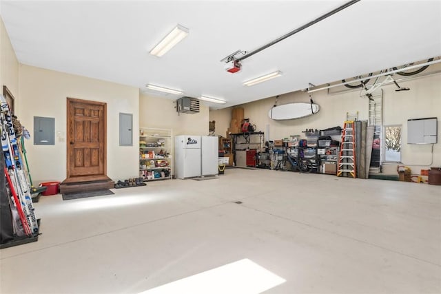 garage featuring a garage door opener, freestanding refrigerator, and electric panel