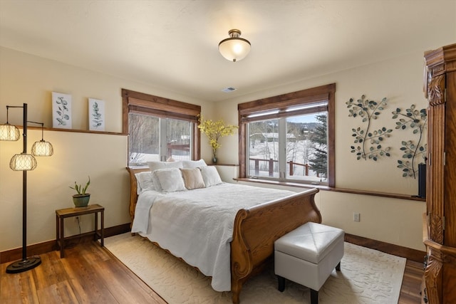 bedroom featuring baseboards and wood finished floors