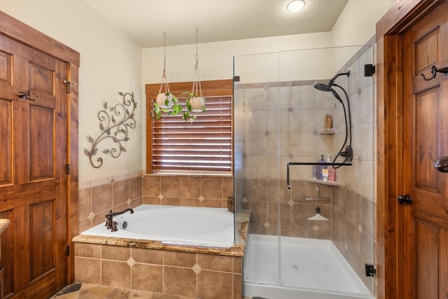 bathroom featuring a stall shower and a bath