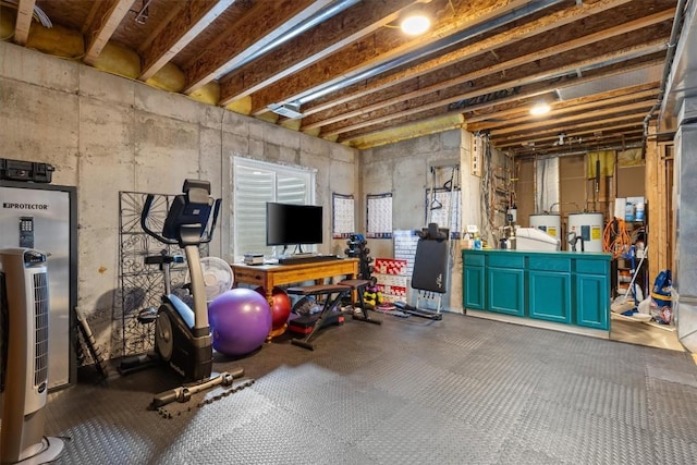 exercise area featuring washer / clothes dryer and electric water heater