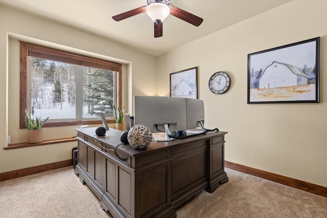 office area with light carpet, baseboards, and a ceiling fan